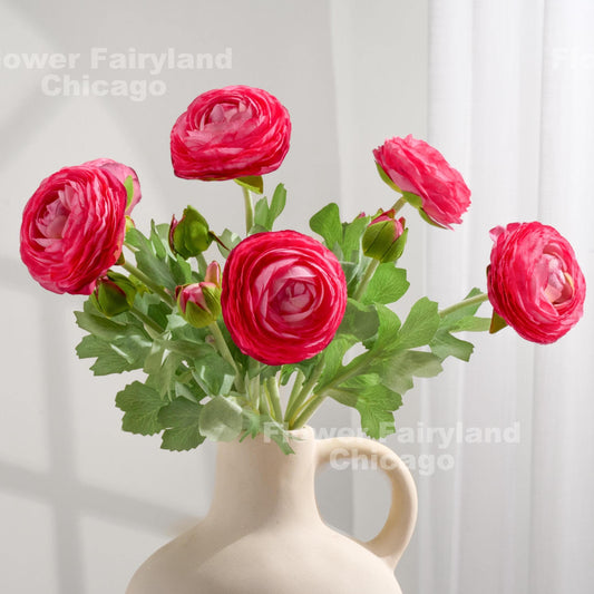 Dark pink faux ranunculus stems in a vase