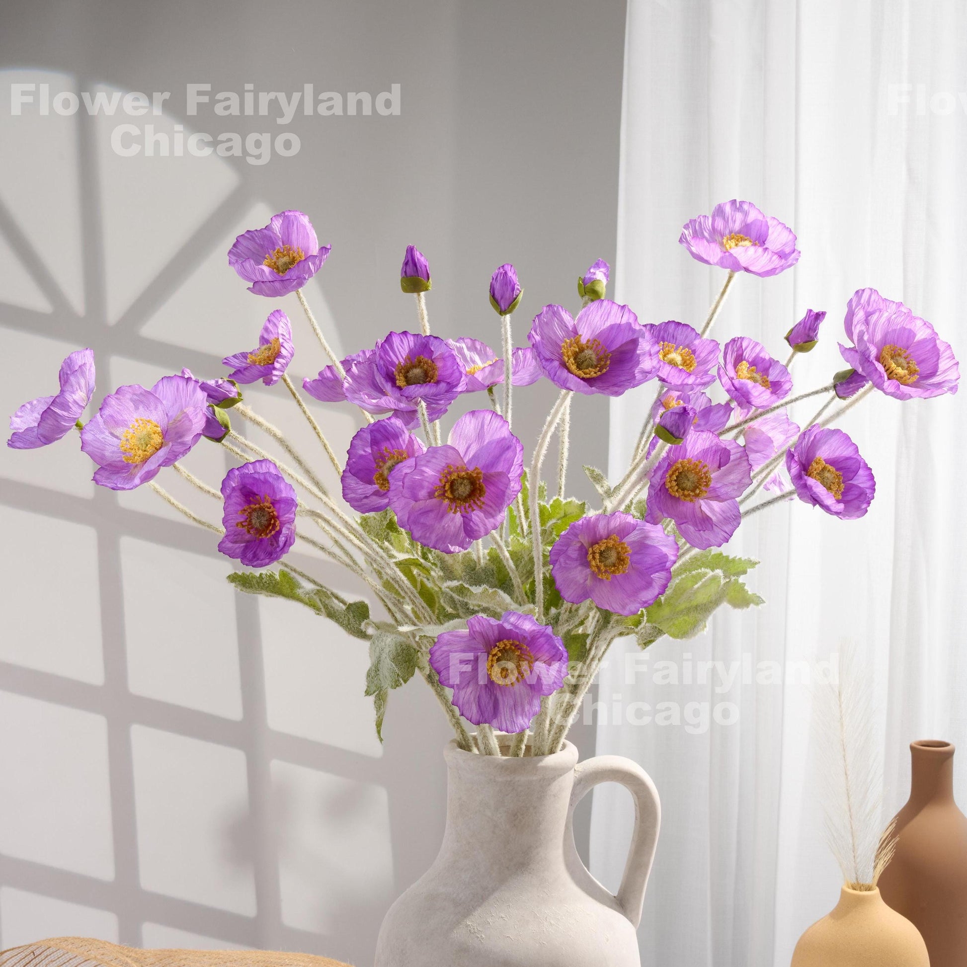 Violet purple faux poppy stems in a vase