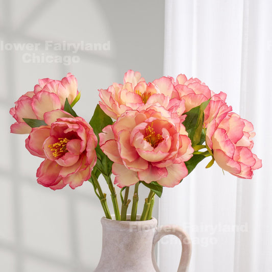 Coral faux peonies styled in a pitcher vase