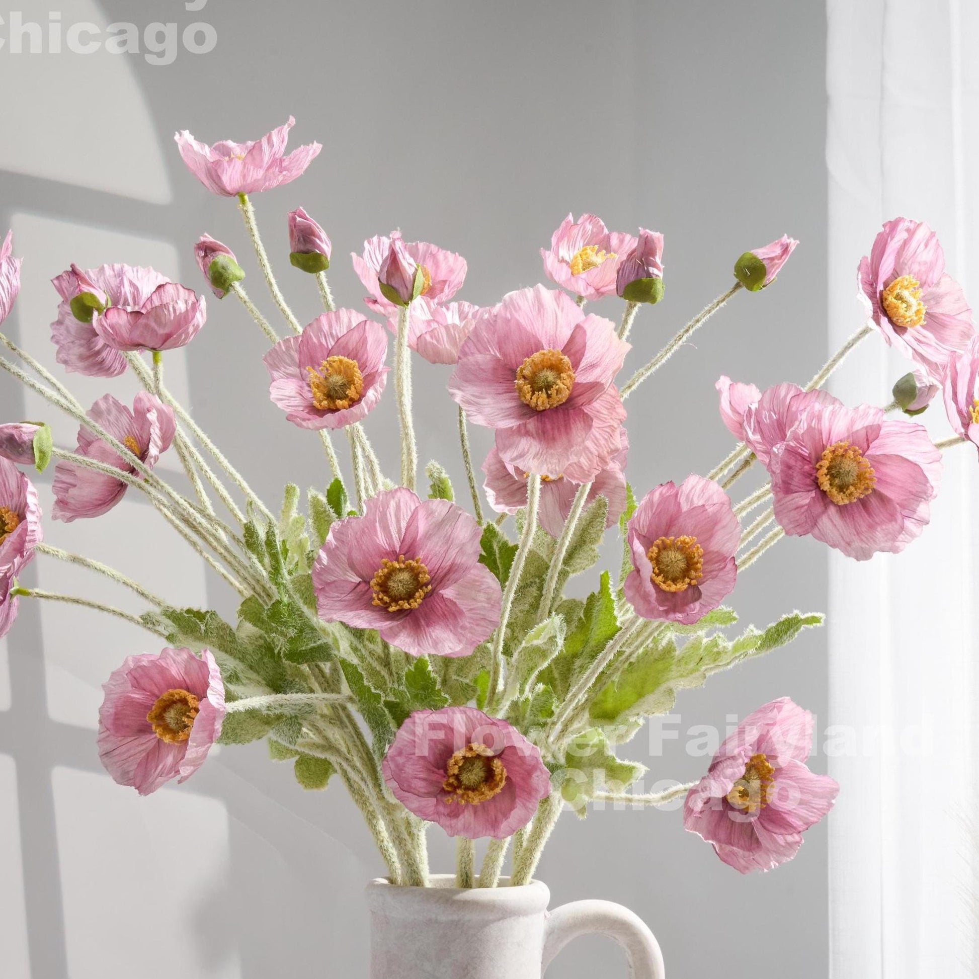 Lilac mauve faux poppy stems in a vase