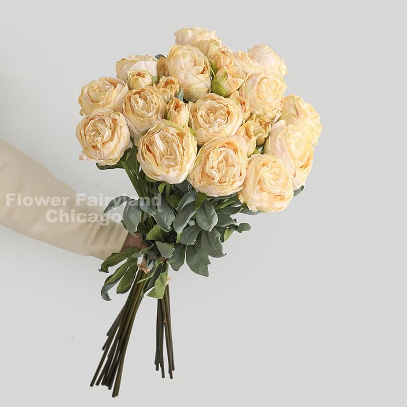 Yellow dried look peony and rose bouquet in a vase