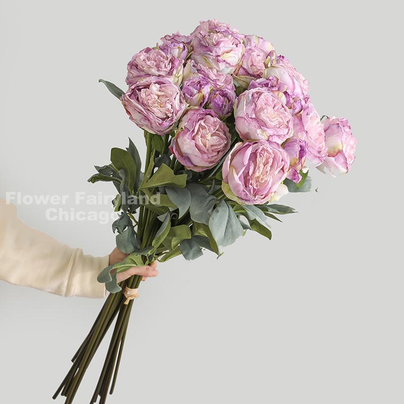 Light purple dried look peony and rose bouquet in a vase