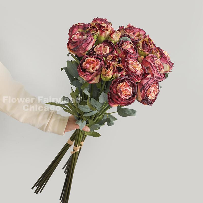 Burgundy dried look peony and rose bouquet in a vase