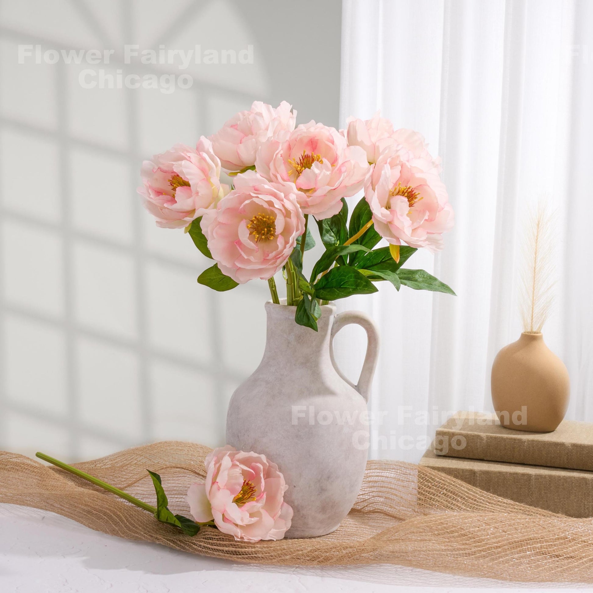 Light pink faux peony arrangement on a table