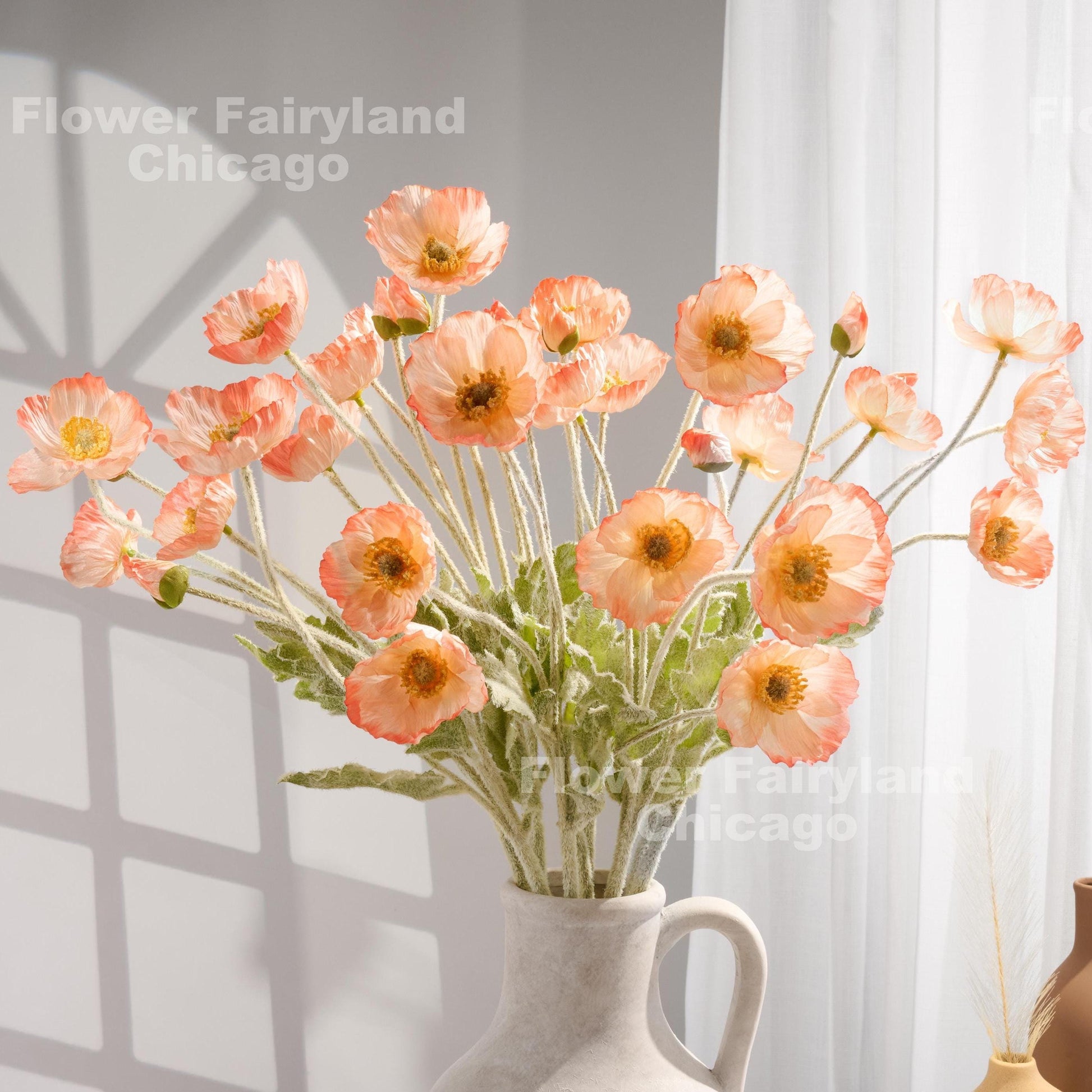 Salmon edge faux poppy stems in a vase