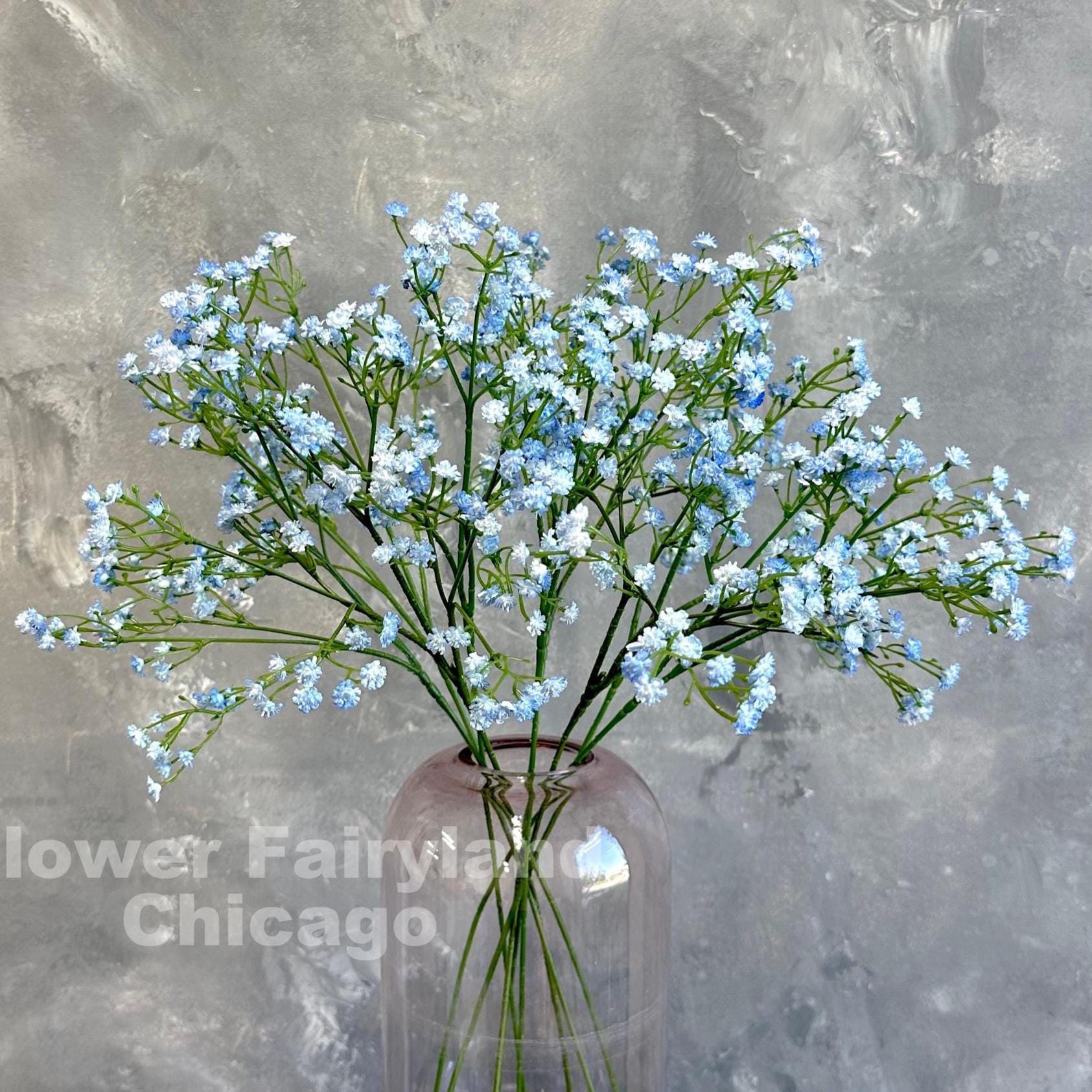 Light blue faux baby's breath styled in a vase