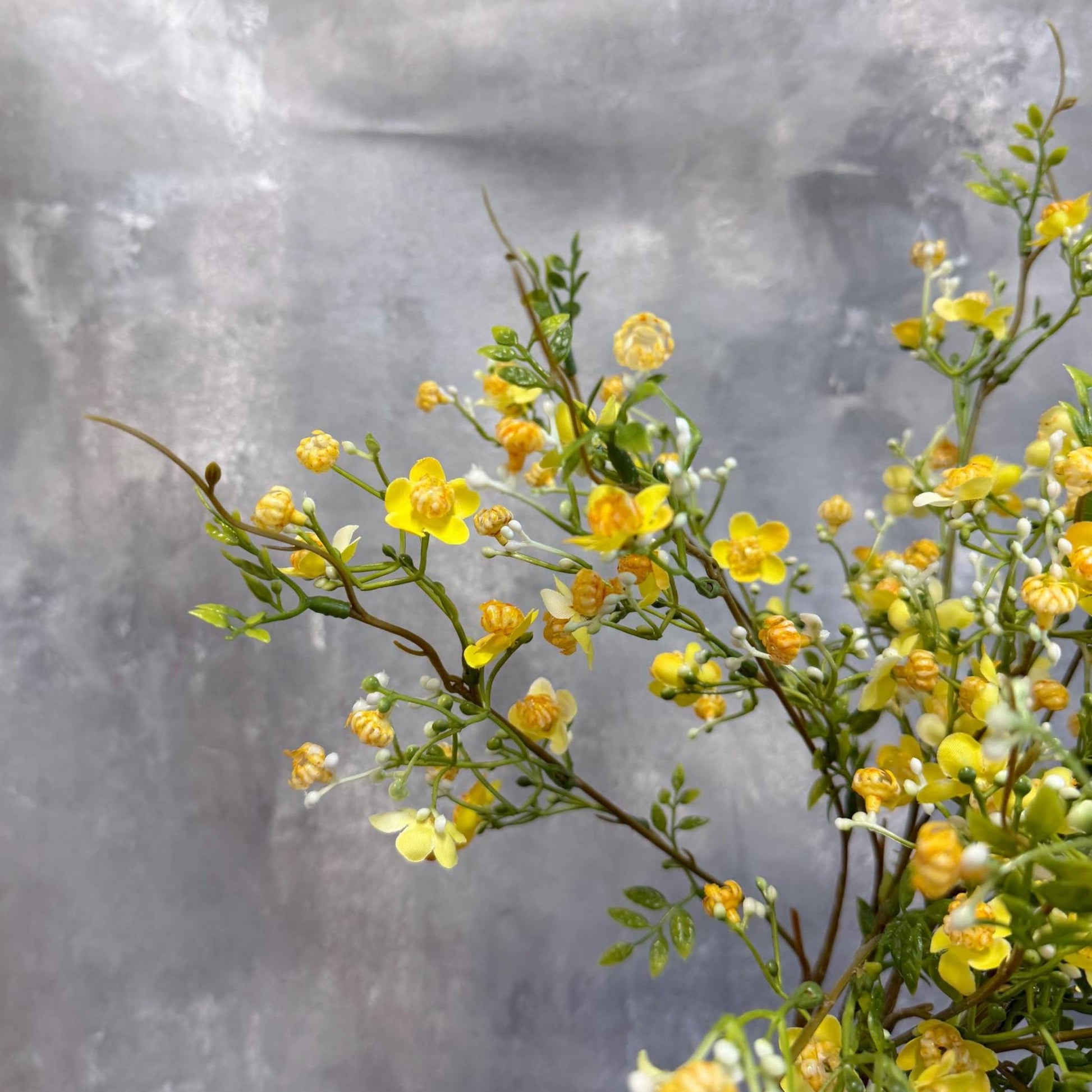 Faux wax flower stem in yellow