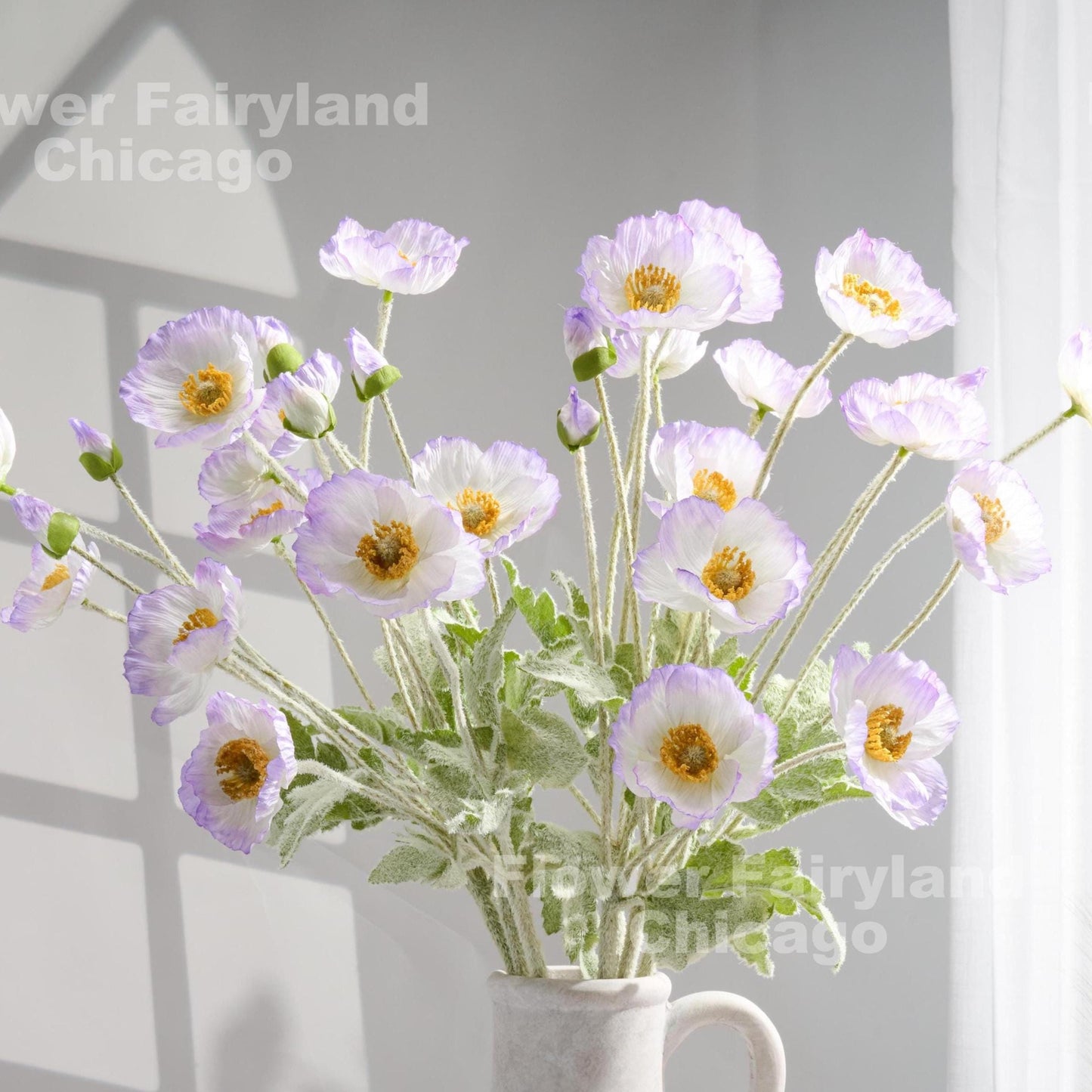 Lavender edge faux poppy stems in a vase
