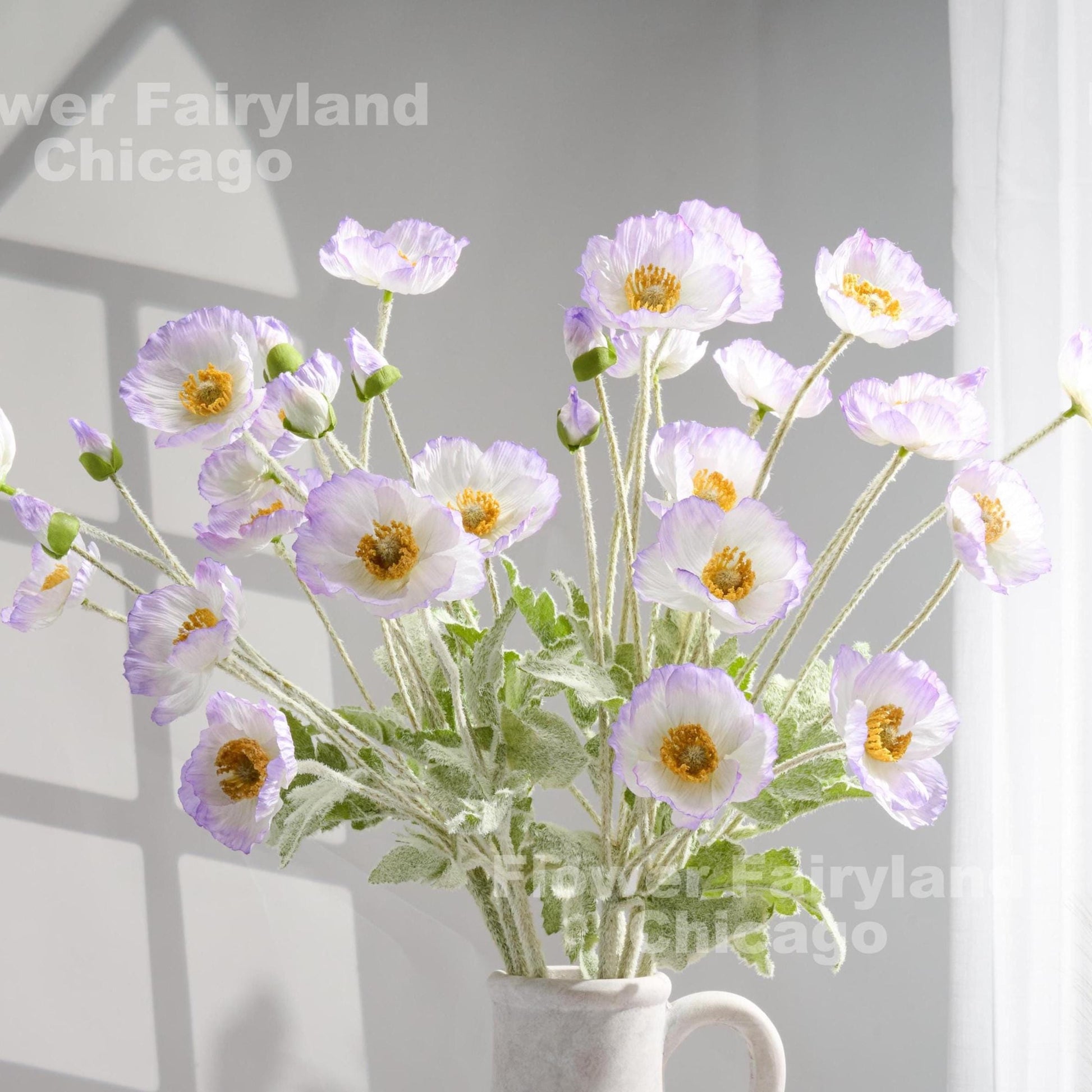 Lavender edge faux poppy stems in a vase