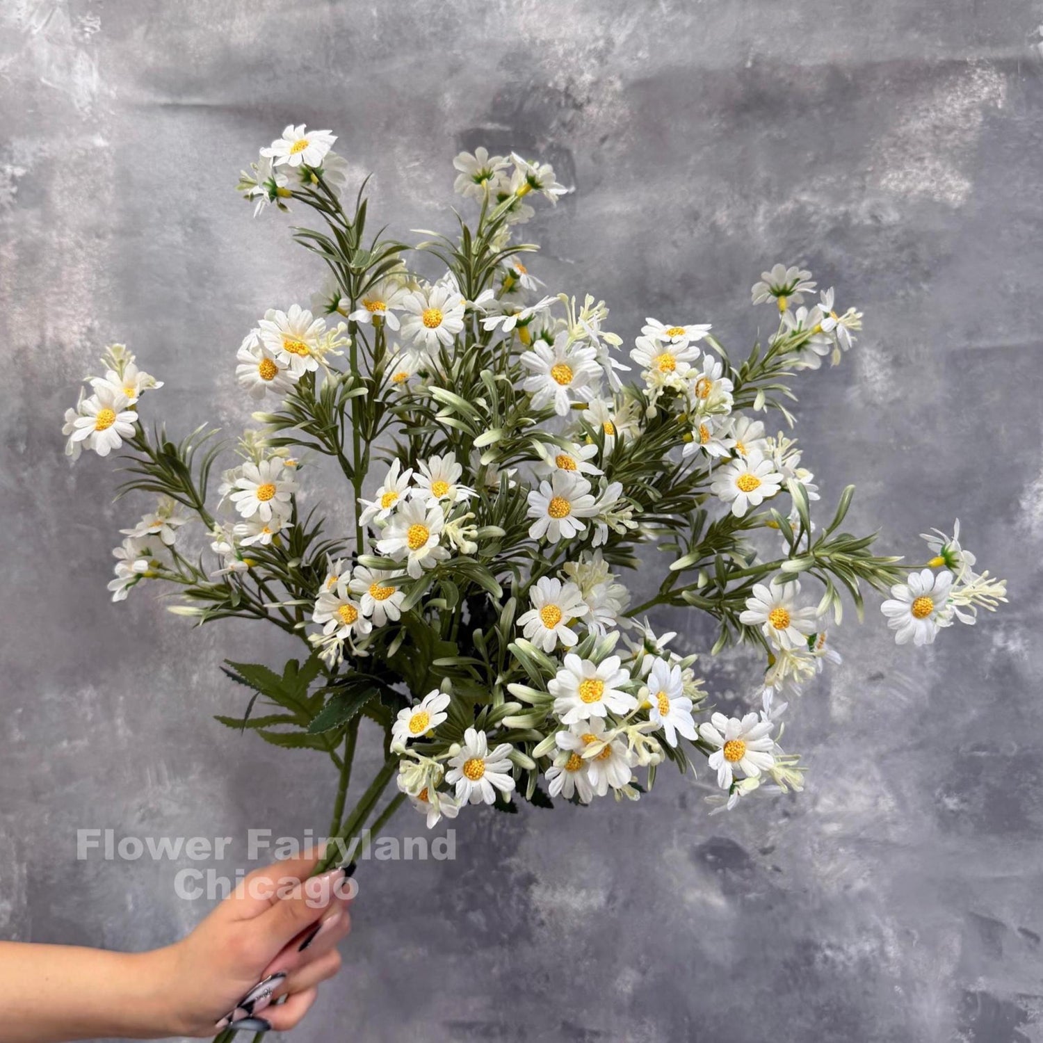 Faux chamomile daisy spray held in hand