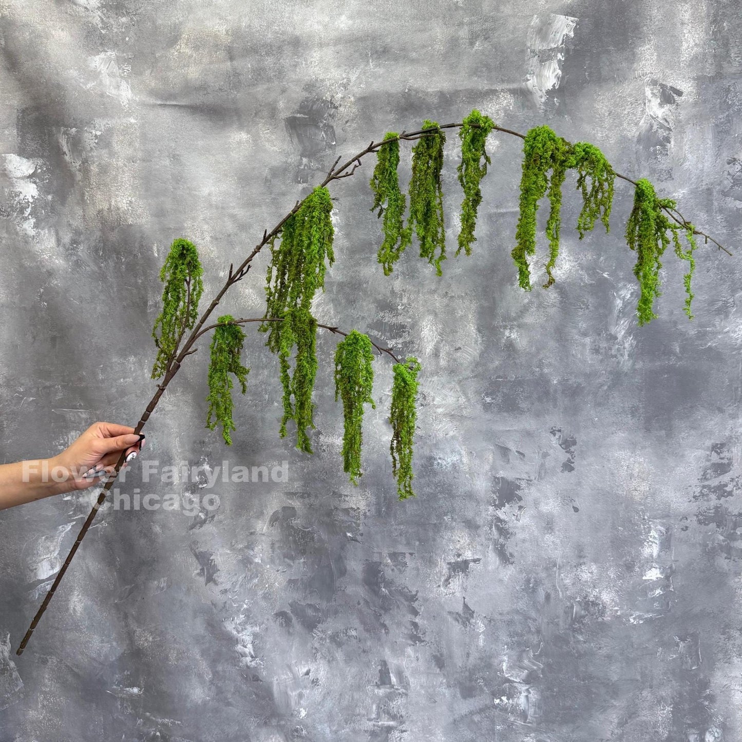 Faux weeping moss branch close-up