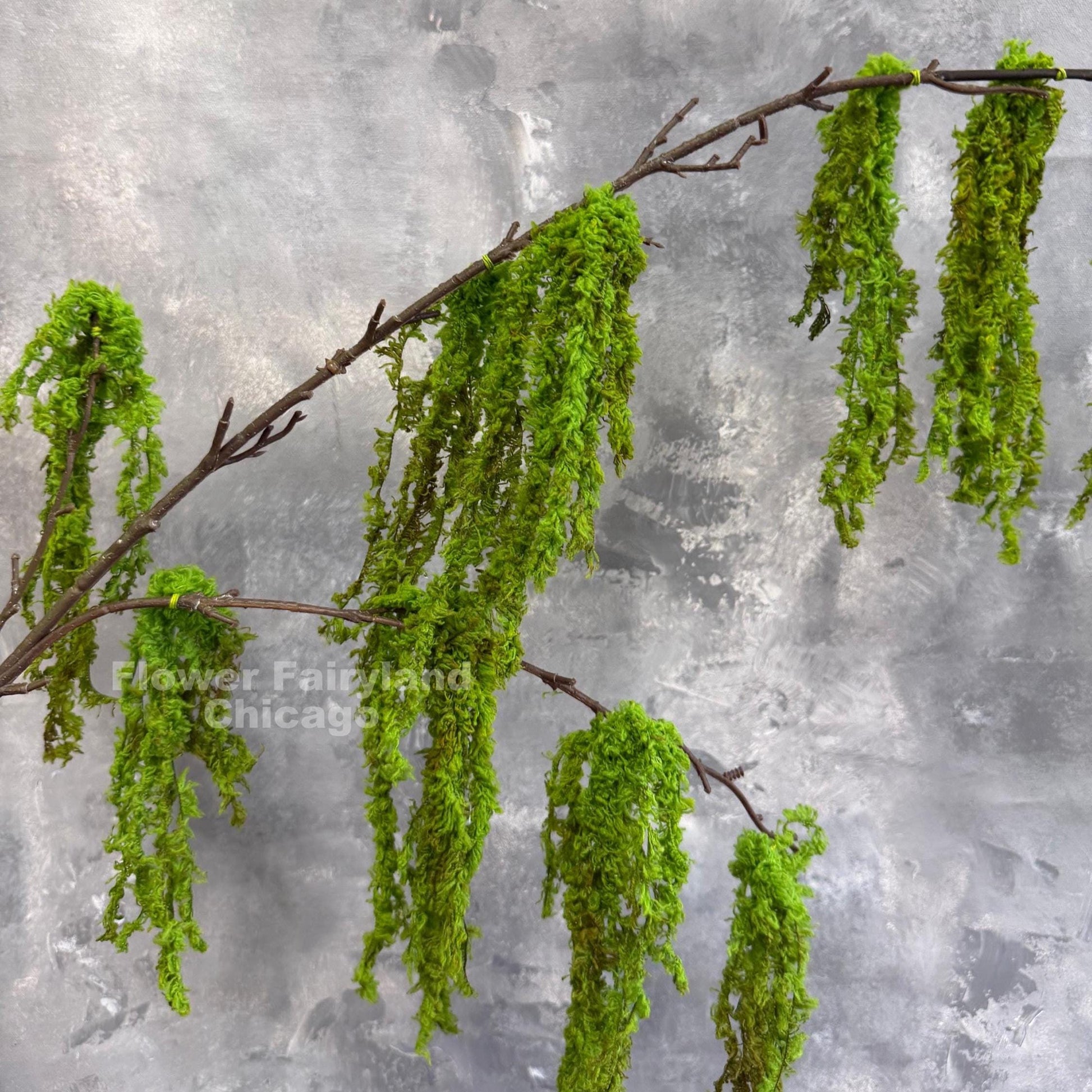 Faux weeping moss branch in vase