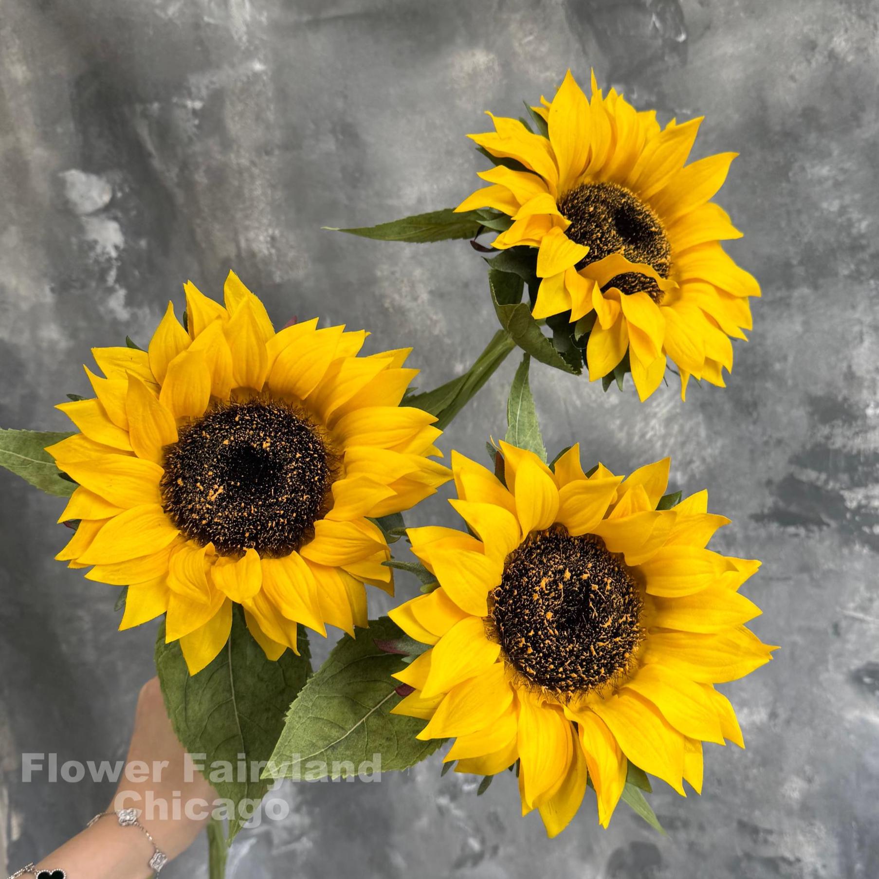 Yellow real touch sunflower blooms close-up